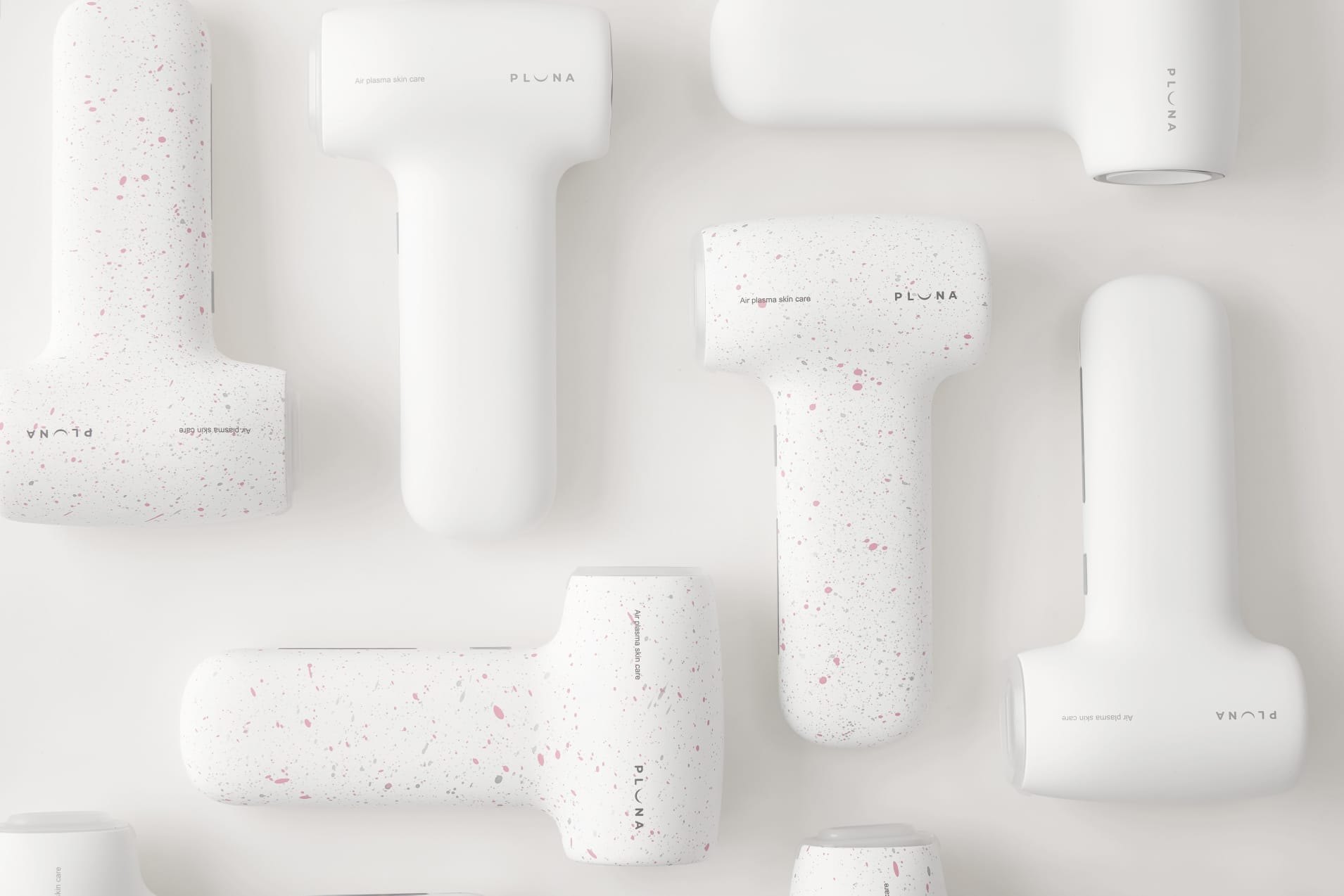 PLUNA devices in White and Pink Terrazzo, arranged as a pattern