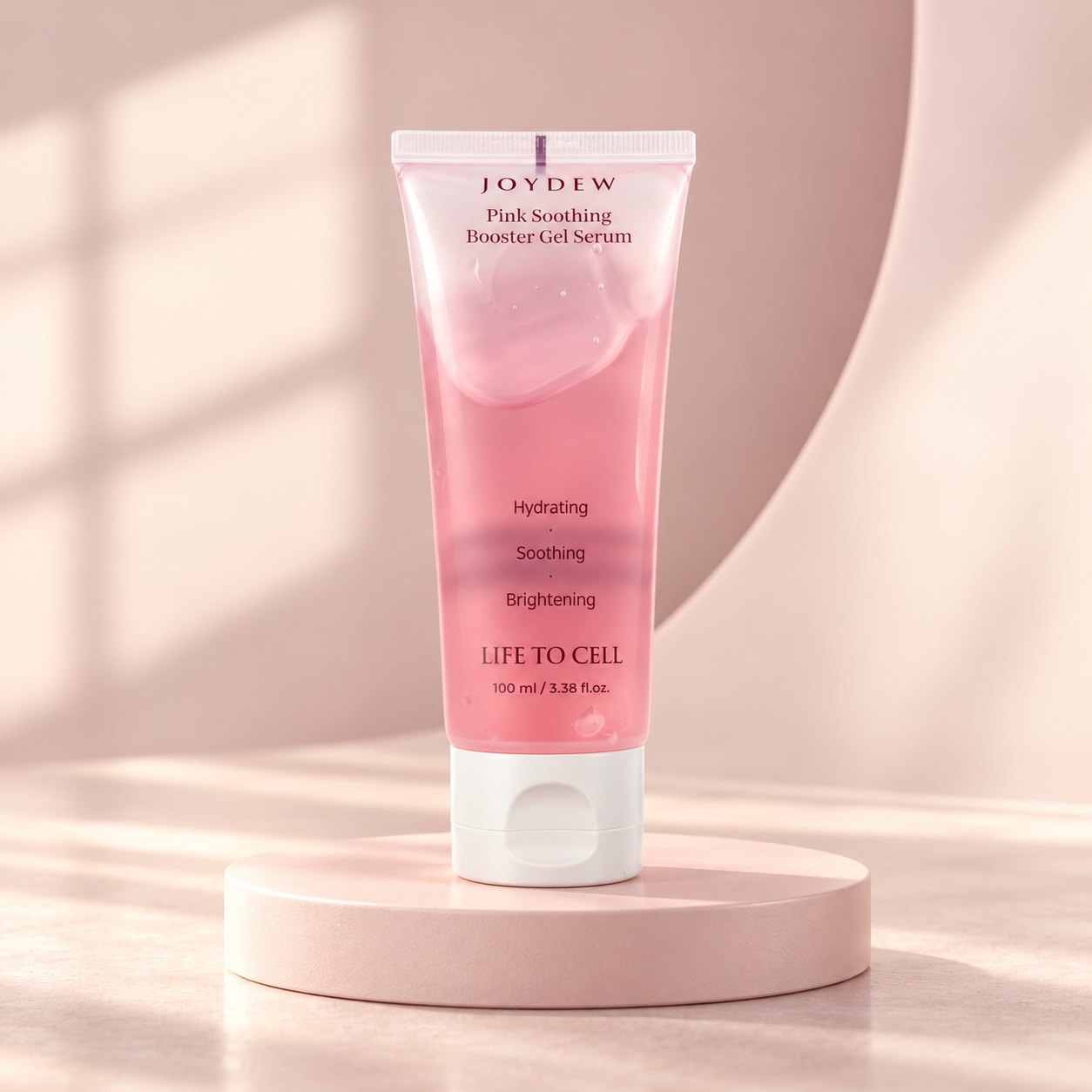 JOYDEW Pink Soothing Booster Gel Serum on a pink podium